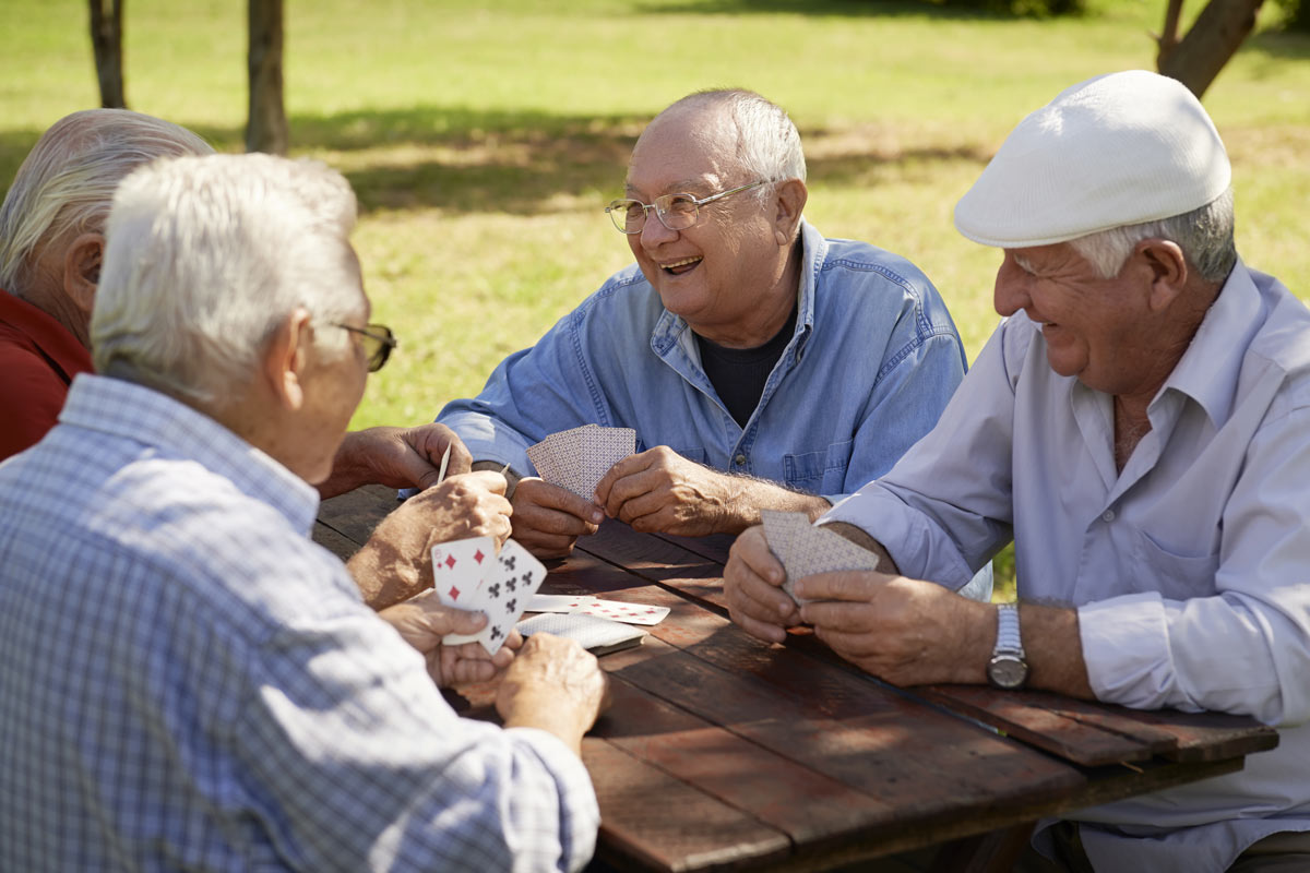 Happy Seniors Playing Cards Outside