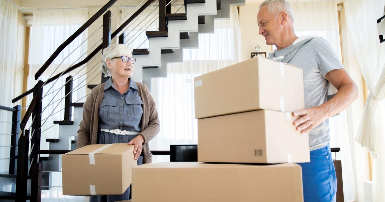 VRS Ross Place portrait of happy senior couple packing cardboard boxes