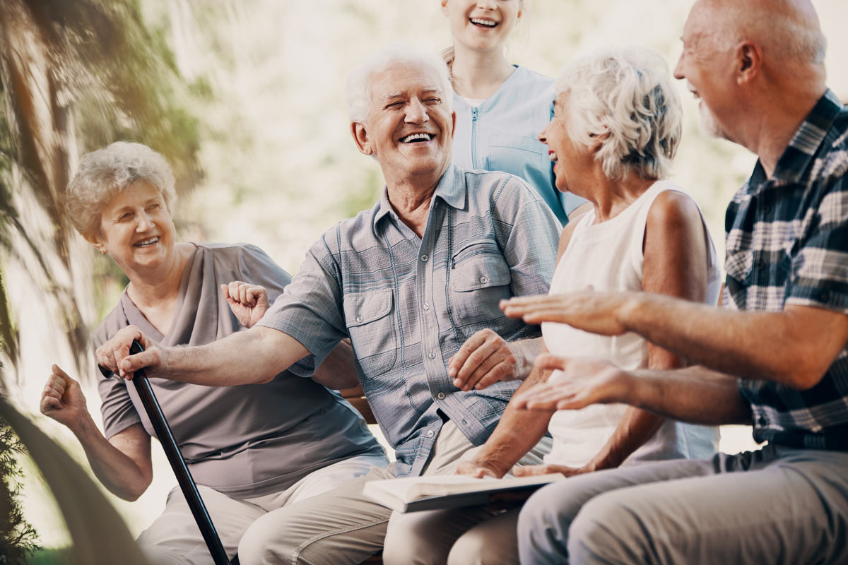 Seniors Sitting Outside Laughing at Victoria VRS Retirement Community