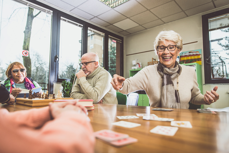 Seniors playing games at independent or assisted living community in Victoria